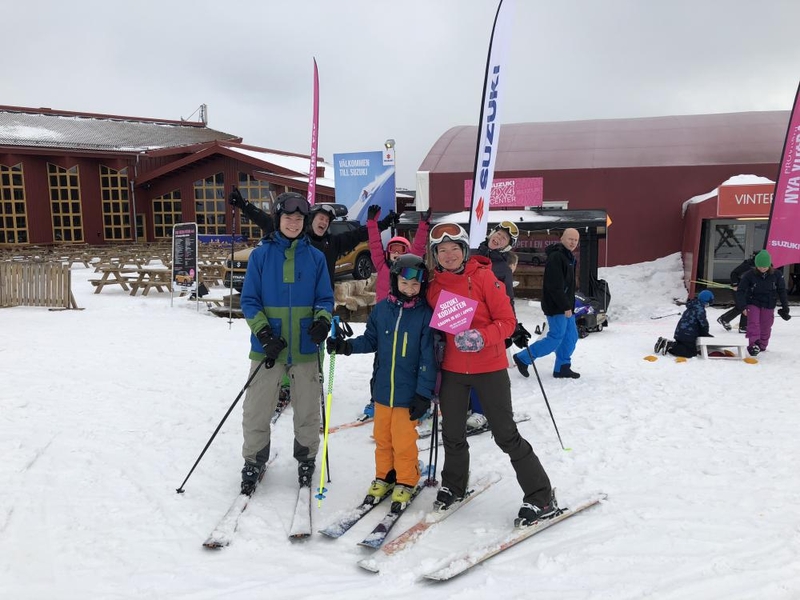 Kollegor och familj som åker skidor